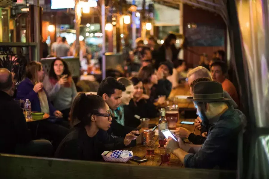 People eating in a crowded dining area in SoMa. San Francisco, California.