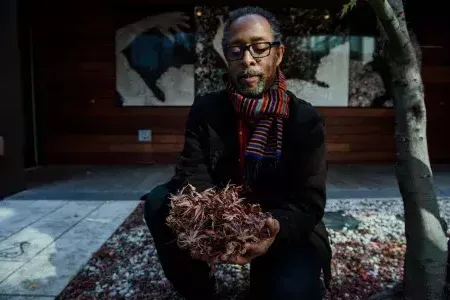 Ron Moultrie Saunders holding leaves.